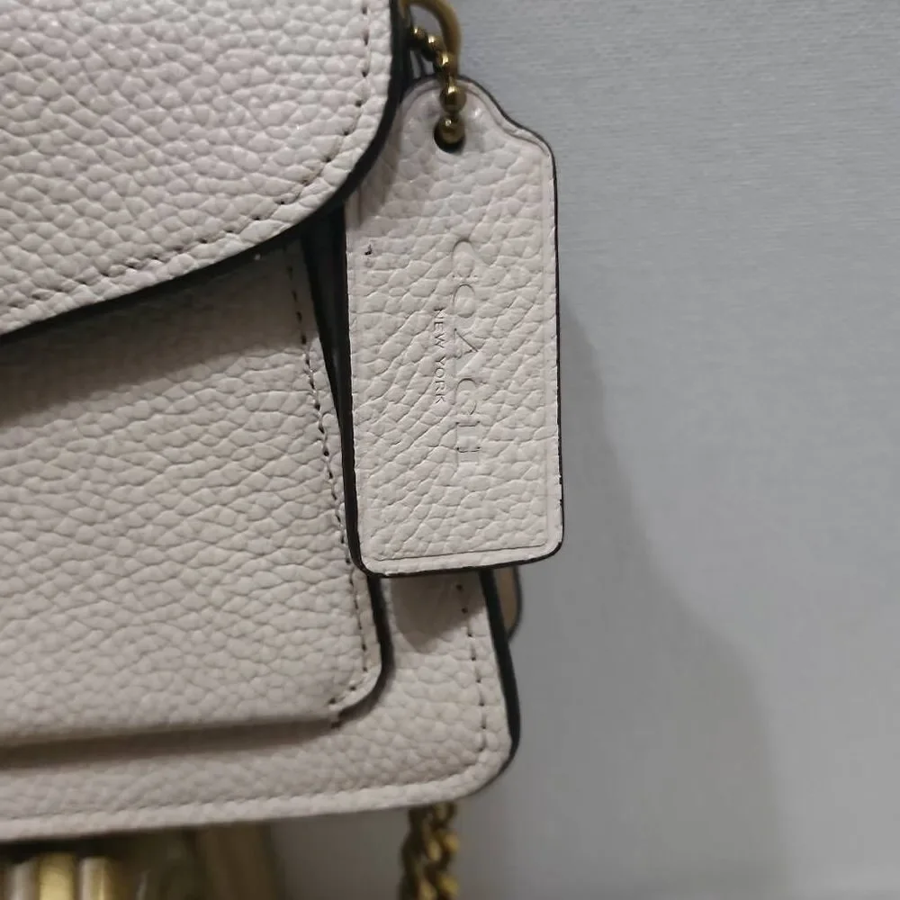 Coach Tabby Mini Chain Clutch in Chalk pebbled leather with gold-tone upgraded c